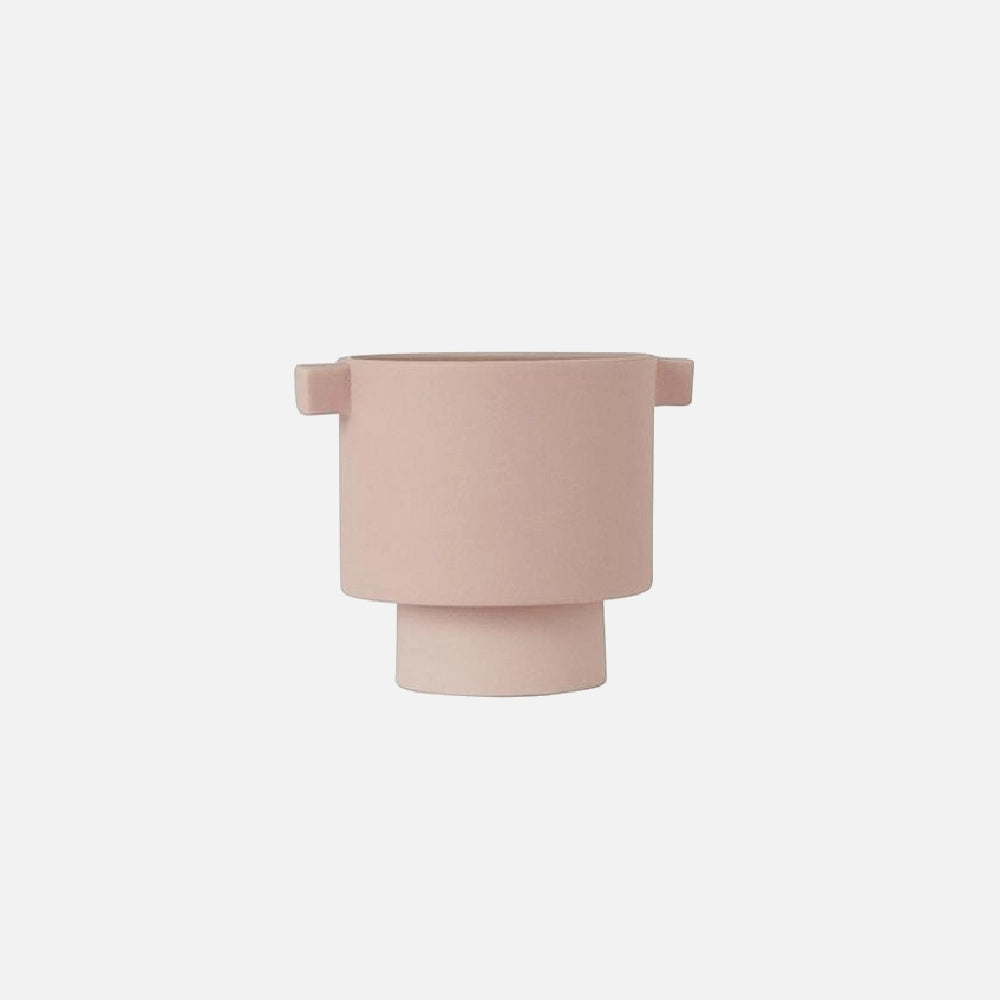 Small rosewater-colored ceramic vase in Scandinavian design, hand-molded with earthy tones, displayed on a wooden surface.