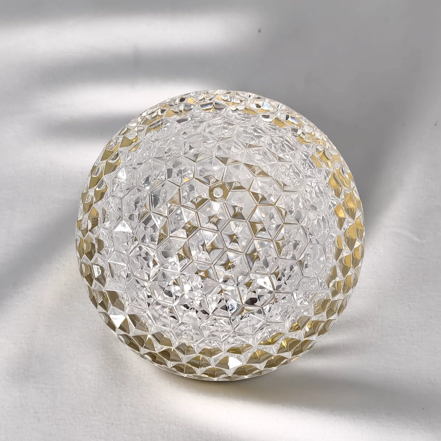 Silver cordless rechargeable LED table lamp with a dimmable and modern design, featuring a circular pattern and metal body.