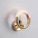 Rotatable wall lamp with a luxurious metallic design, featuring an intricate circle and gemstone details reminiscent of fine jewelry.