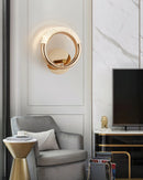 Luxurious metallic rotatable wall lamp mounted above a couch in a well-designed interior, highlighting the comfortable and stylish setting.