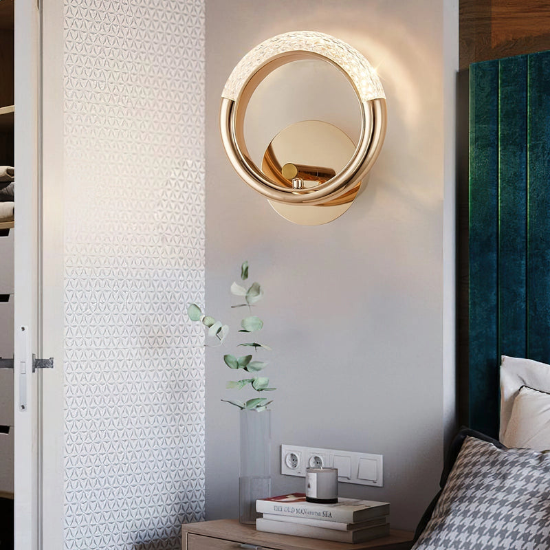 Luxurious metallic wall lamp with an adaptable angle, showcased in an elegantly designed interior featuring wood elements and architectural details.