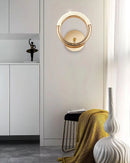 Luxurious metallic wall lamp with a rotatable angle, featuring a yellow light illuminating an elegant interior design.