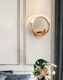 Luxurious metallic rotatable wall lamp mounted on a wooden wall, featuring a sleek rectangular design in a stylish interior setting.