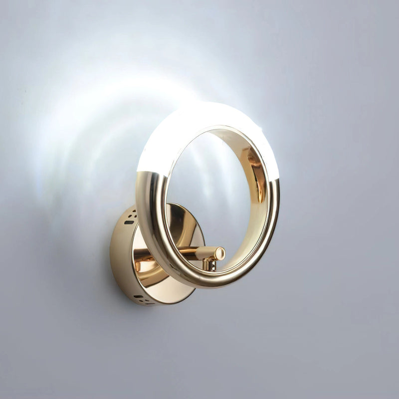Luxurious metallic wall lamp with a rotatable angle, featuring an oval-shaped design and a glossy finish, resembling a sophisticated door handle or fashion accessory.