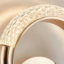 Luxurious metallic rotatable wall lamp with a gold finish, featuring circular patterns and wood accents, showcasing both artistic and fashionable elements.