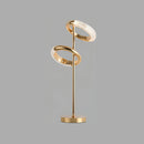 A modern adjustable wall lamp with a mix of wood and metal elements, featuring a circular and rectangular design in gold finish.