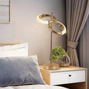 Adjustable Nordic style wall lamp with rotatable design displayed in a room setting with furniture, including a table, showcasing a cozy interior design with wooden accents.