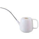 Modern and functional April Showers Garden Watering Can, displayed among various kitchen items including cups and utensils, showcasing its sleek metal design.