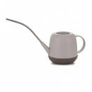 Khaki modern and functional April Showers garden watering can placed on a table.
