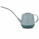 Blue modern garden watering can on a table, designed for functionality and style.