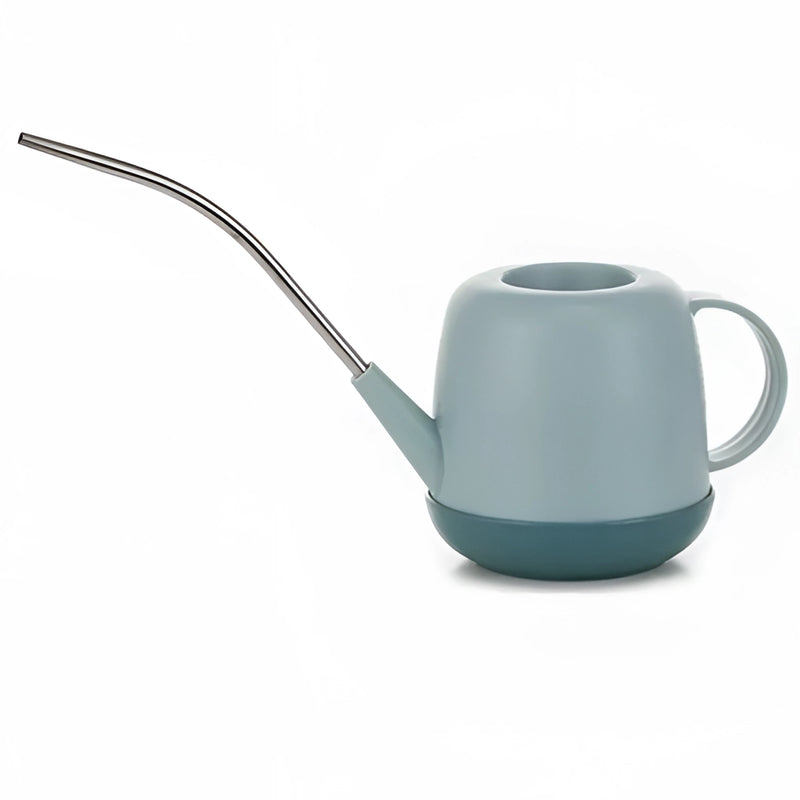 Blue modern garden watering can on a table, designed for functionality and style.
