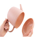 Modern and functional April Showers garden watering can made of wood with a cylindrical design, resembling a coffee cup.