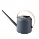 Modern and functional April Showers garden watering can in charcoal and pink, featuring a sleek metal cylinder design with electric blue accents.