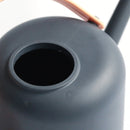 Modern and functional April Showers garden watering can displayed on a table surrounded by various household items.