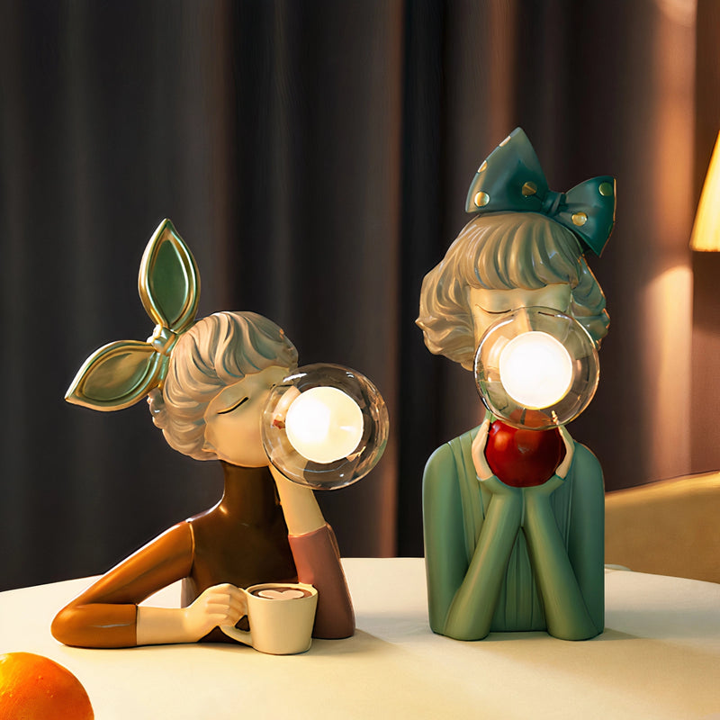 Handcrafted wooden table lamp featuring an artistic design with a whimsical cartoon-like illustration, incorporating elements resembling toys and a hat, set in a still life photography style.