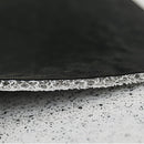 Back to the Future inspired geometric entrance doormat featuring automotive elements like tires and rims, set against a wood-textured background with subtle shades.