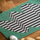 Back to the Future inspired doormat featuring geometric designs in green and white, placed on grass.