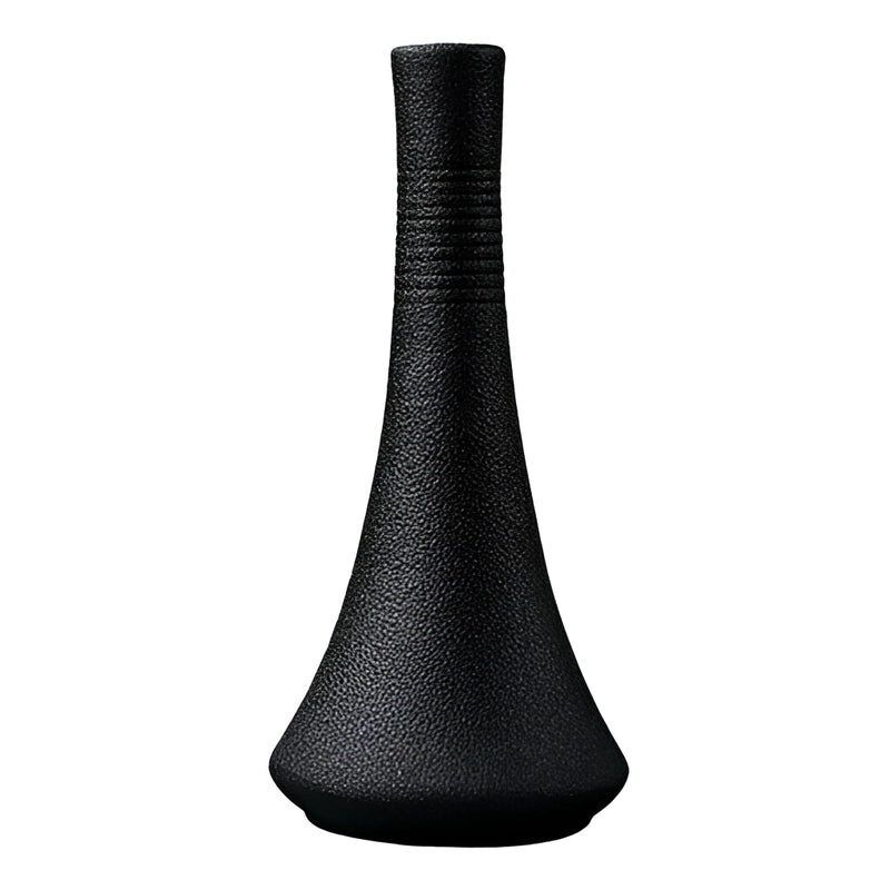 Black ceramic vase with intricate patterns and artful illustrations, displayed as a piece of tableware.