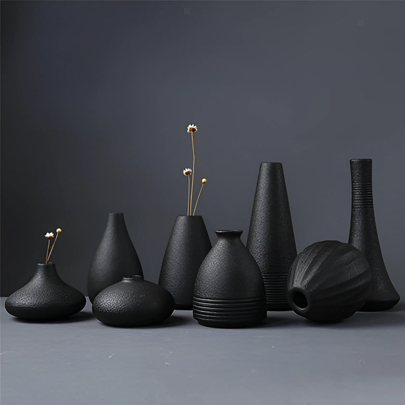 Black ceramic vase displayed in a still life setting, featuring artistic and creative design elements, suitable for both home and garden use.