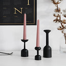 Black wooden candle holder set displayed with a twig, designed for home decor.