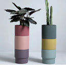 A stack of bright porcelain flowerpot planters designed for houseplants, featuring a clean, rectangular shape and artistic aesthetic.