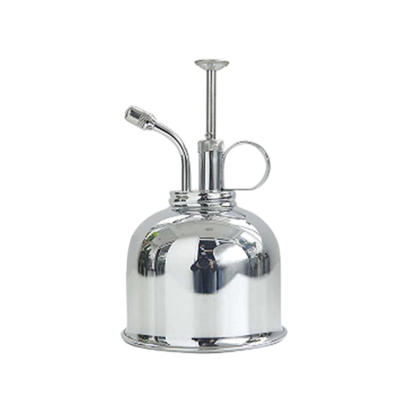 Silver vintage brass plant mist sprayer with a metallic and glass design, displayed on a table.
