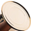 Vintage brass watering spray bottle for plants on a table, surrounded by various household items.