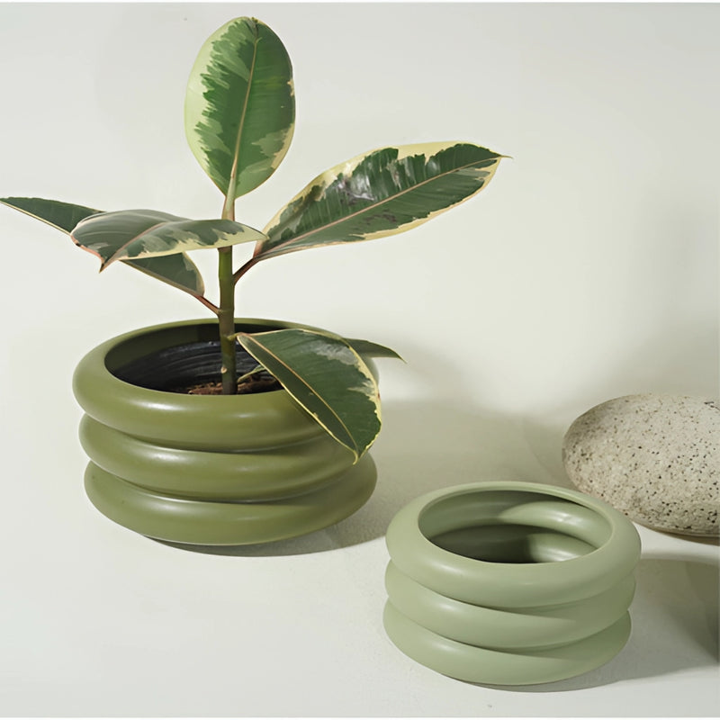 Bubble Glass Planter Vase featuring a round ceramic design with a houseplant in a flowerpot, surrounded by various pottery and dishware elements.