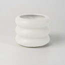 White ceramic round bubble glass planter vase on a table, featuring a unique porous texture and designed for decorative purposes.