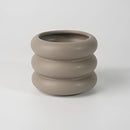 Bubble Glass Planter Vase featuring a ceramic round design with a wood-like appearance, displayed on a table setting among other dishware elements.