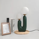 Cactus design table lamp featuring milk glass globes on a wooden base, illuminated by LED lights.