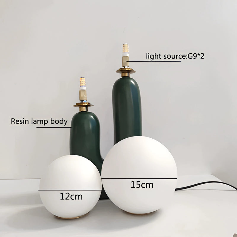 Decorative cactus design table lamp featuring milk glass globes and LED light, crafted with metal and wood elements, styled to resemble a piece of art.