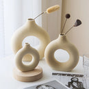 Ceramic donut-shaped vase made of porcelain, designed for modern home decor, displaying a circular, wood-textured appearance.