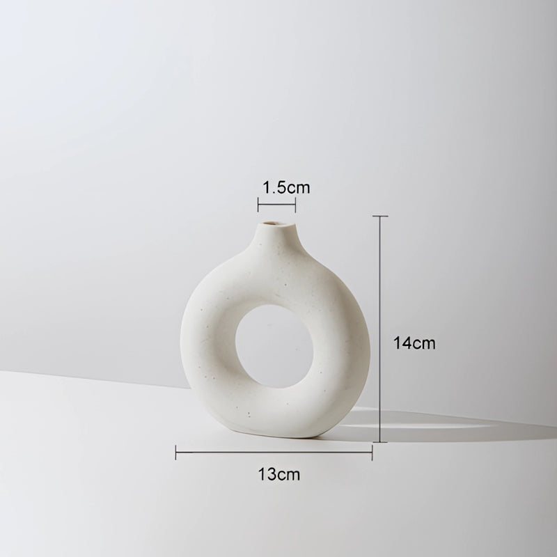 White small ceramic donut-shaped vase for modern home decor, featuring a circular and oval design, made of porcelain.
