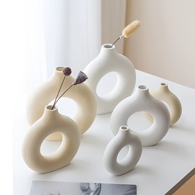 Ceramic donut-shaped vase featuring a sleek, modern design, ideal for contemporary home decor.