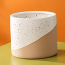 Small, medium, and large ceramic flowerpots in linen color, displayed on a table, featuring pottery and earthenware designs.