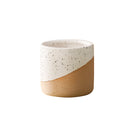 Small ceramic flowerpot in linen color, resembling drinkware with a cylindrical pottery design.