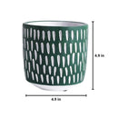 Hand-painted green ceramic planter with textured designs, displayed in a cylindrical shape with patterns visible on its surface.