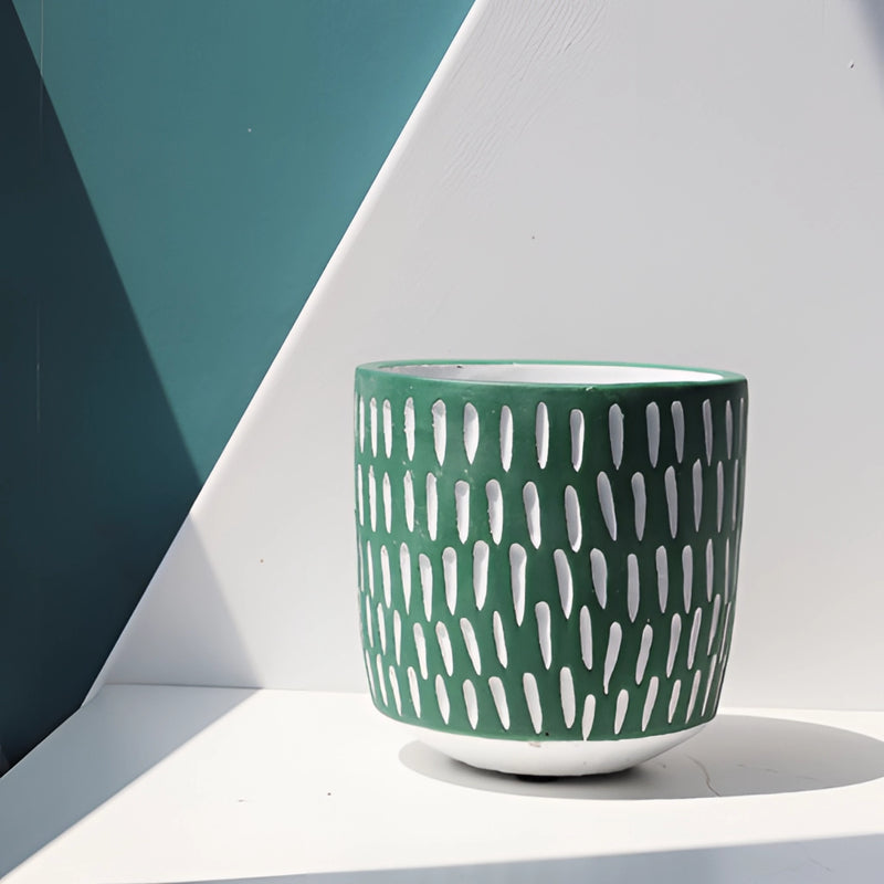 Hand-painted ceramic planters with textured designs, displayed on a table resembling dishware and drinkware settings.