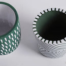 Hand-painted ceramic planters featuring textured, artistic designs in shades of electric blue, displayed in a circular arrangement.