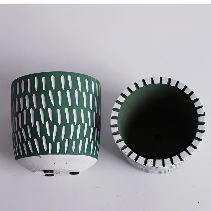 Hand-painted ceramic planters with textured designs in electric blue, displayed on a table, featuring intricate patterns.
