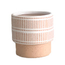 Ceramic plant pots in various shapes including cylinder and rectangle, displayed on a wooden surface with metal and leather accents, featuring a peach color theme.