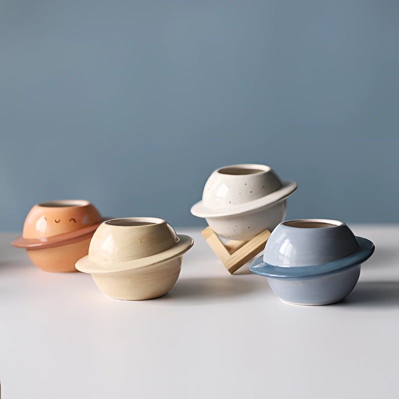 Ceramic planet-shaped plant pot with an astral galaxy design, showcasing artistic pottery craftsmanship.