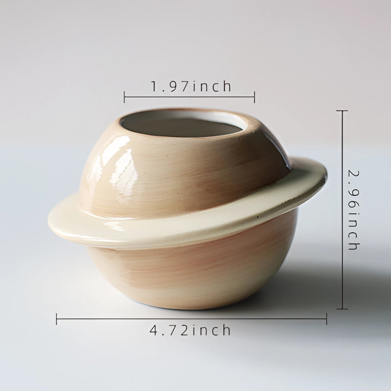Yellow Ceramic Planet Plant Pot with Astral Galaxy Design displayed on a wooden surface, featuring creative arts and pottery aesthetics.