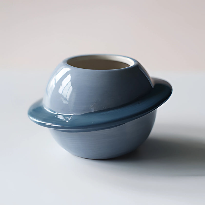 Blue ceramic plant pot with an astral galaxy design, featuring vibrant electric blue tones and circular patterns.
