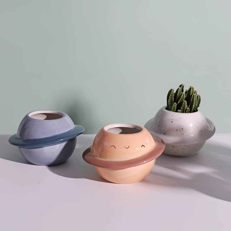 Ceramic plant pot with an astral galaxy design, featuring a blend of artistic and pottery elements, ideal for holding small plants or as a decorative piece.
