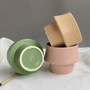 Pink glazed ceramic planter with a smooth, circular Scandinavian style design, displayed on a flat surface.