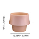 Glazed ceramic planter in rosa with a Scandinavian style, featuring a cylindrical shape and pottery finish.