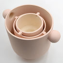 Hand-molded ceramic vase in earthy tones featuring Scandinavian design, displayed among various tableware items.