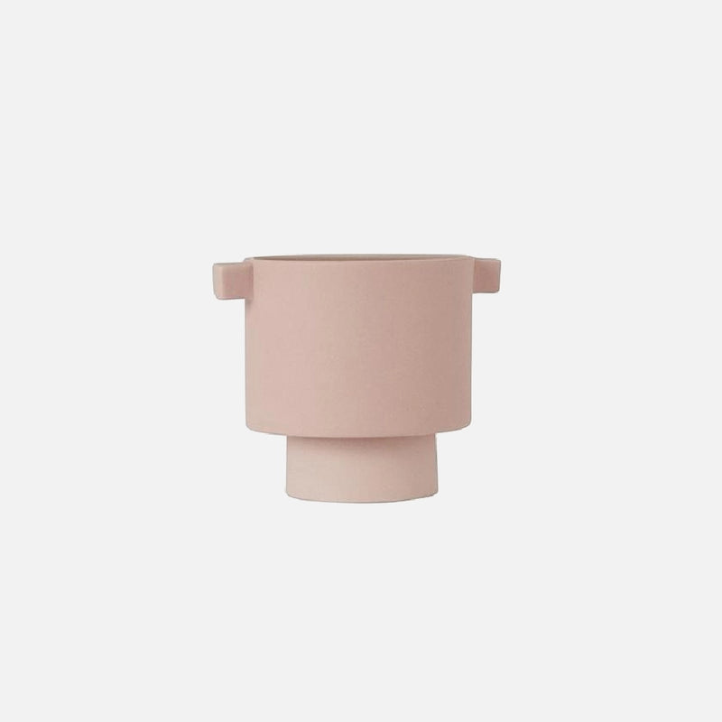 Small rosewater-colored ceramic vase in Scandinavian design, hand-molded with earthy tones, displayed on a wooden surface.